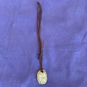 Tan and cream mother and child cameo necklace.